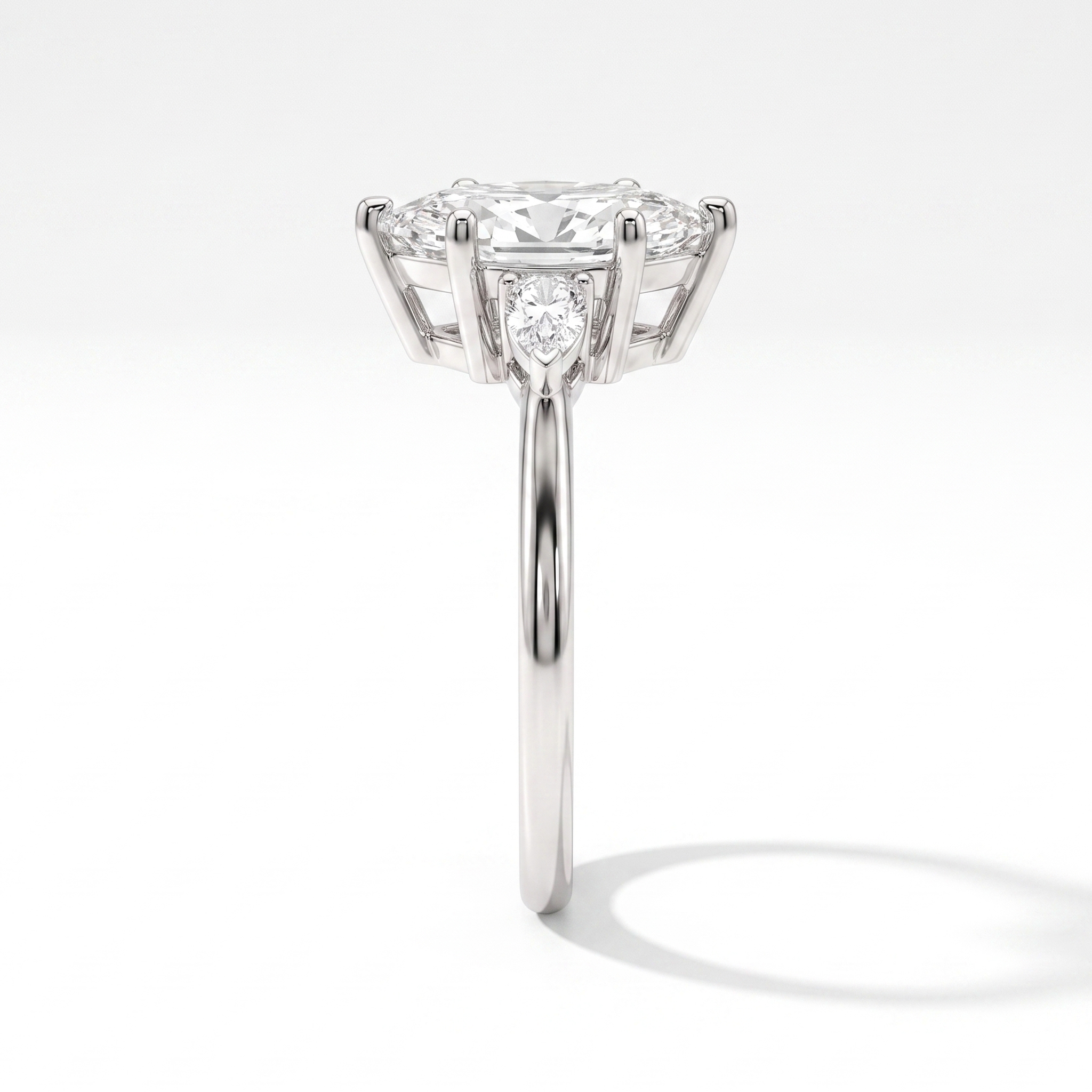 Marquise engagement ring with pear accents, side profile, white gold shown